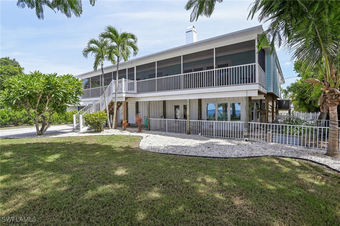 a front view of a house with swimming pool having outdoor seating