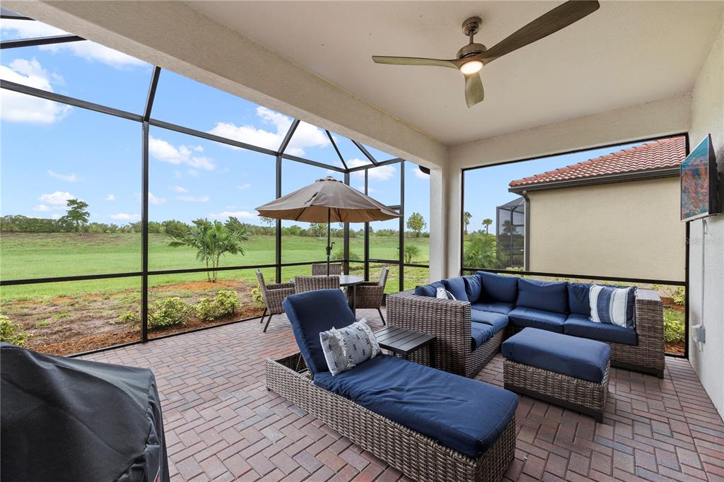 a living room with furniture and a floor to ceiling window