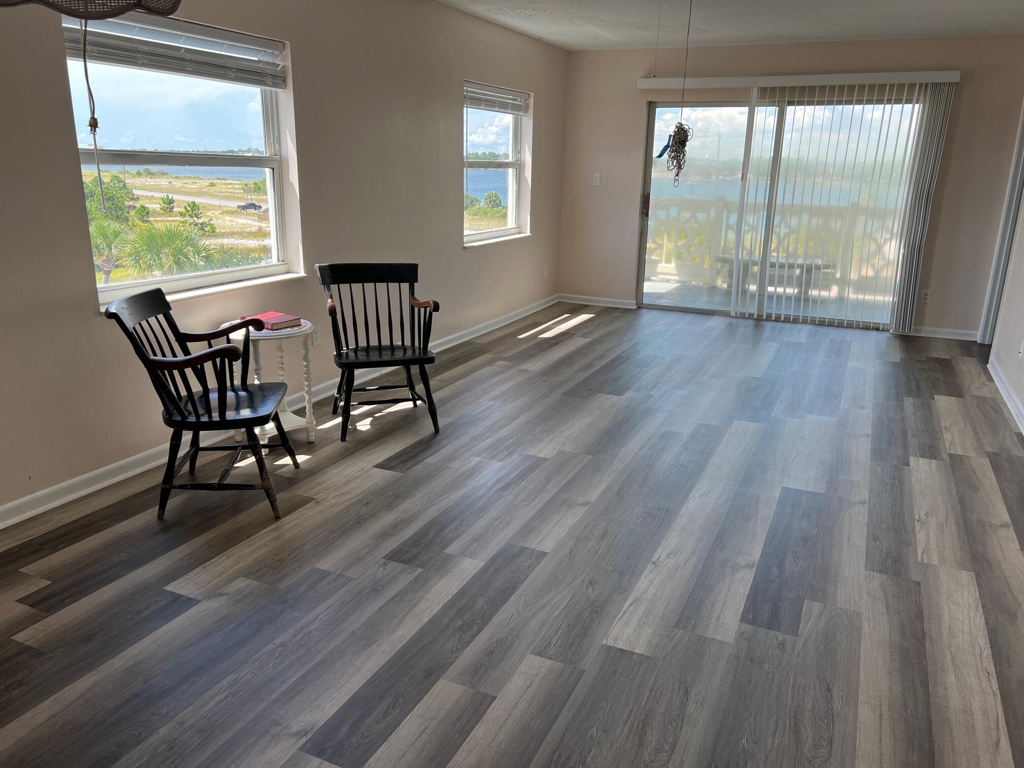 a view of a room with wooden floor and a window