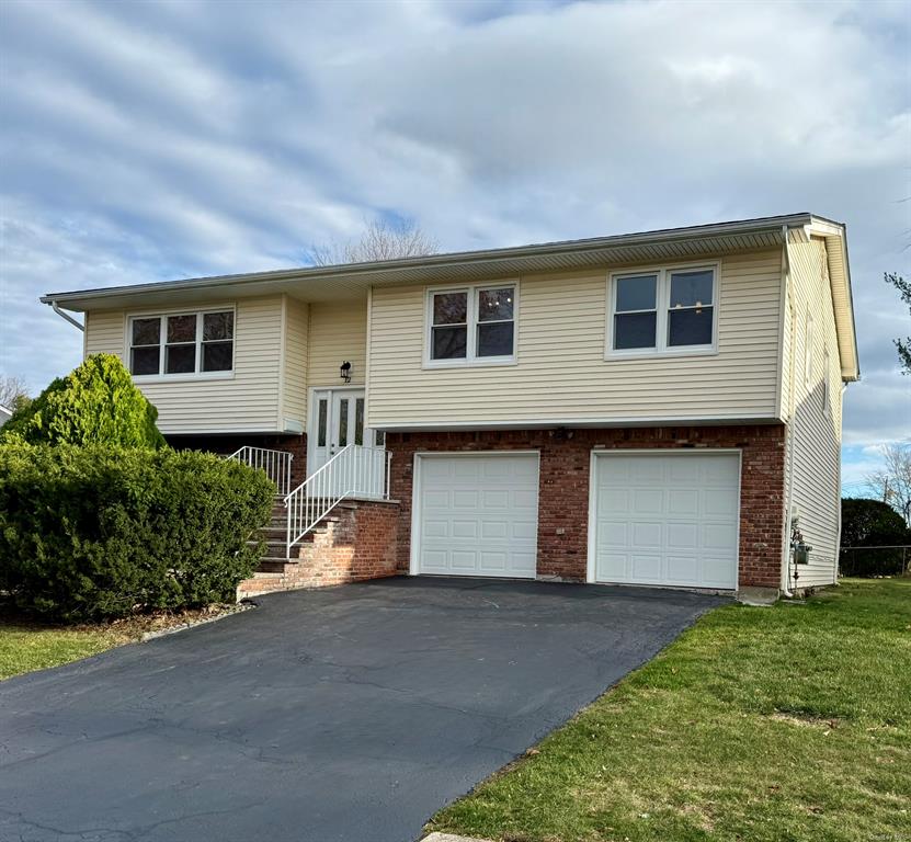 Split foyer home featuring two car garage