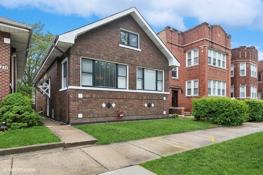 a front view of a house with a garden