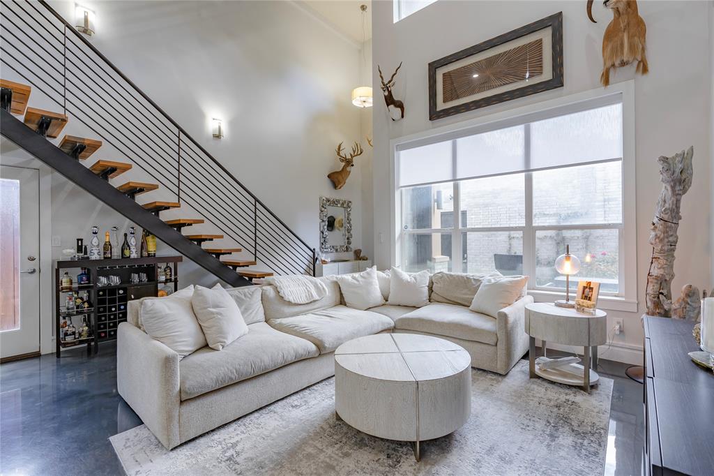 a living room with furniture and a floor to ceiling window