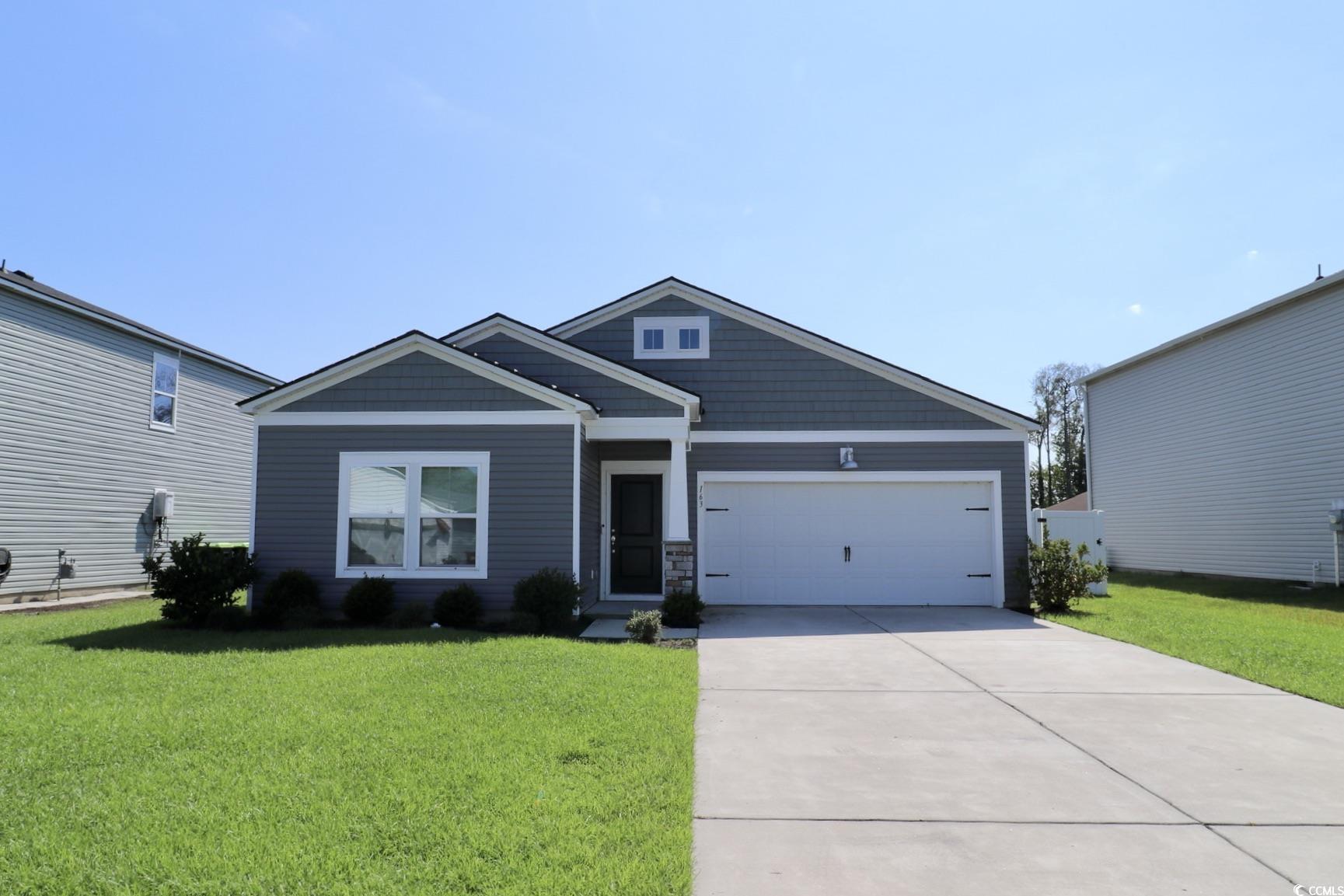 View of front of home featuring a garage and a fro