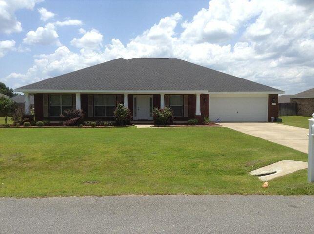 a front view of house with yard and green space