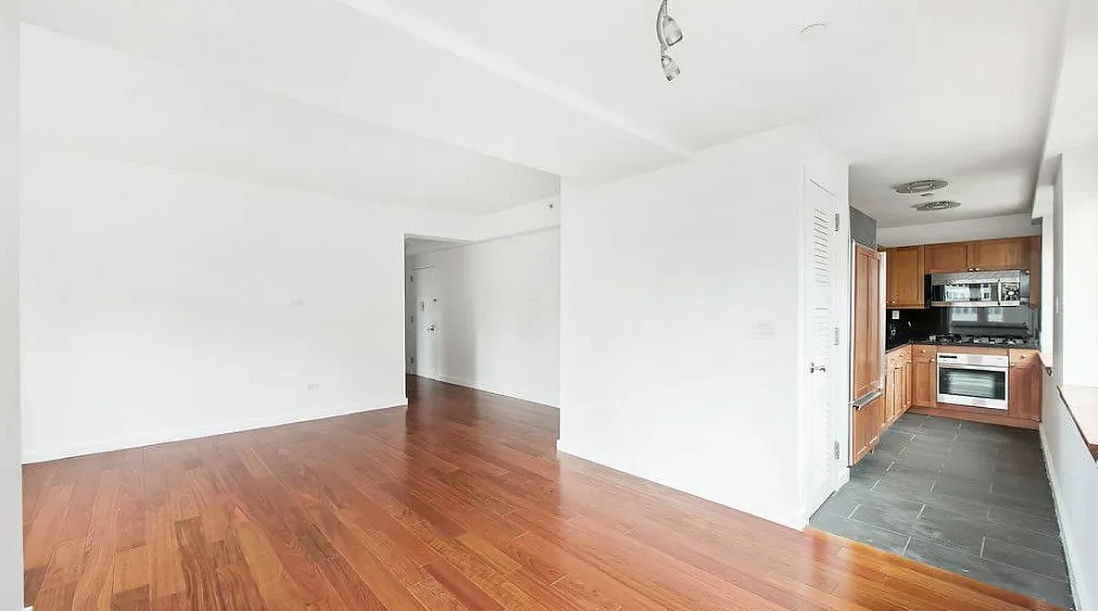 a view of a hallway with wooden floor and a fireplace