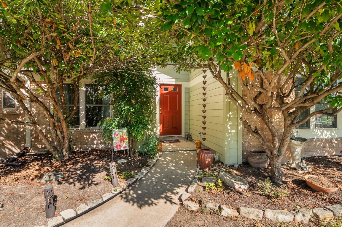 a pathway of a house with a yard