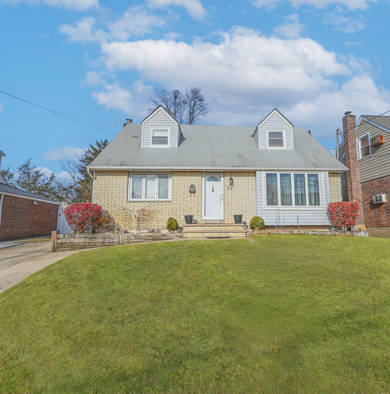 Cape cod home with a front lawn