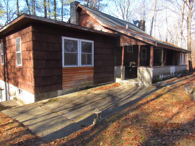 a front view of a house with yard and hallway