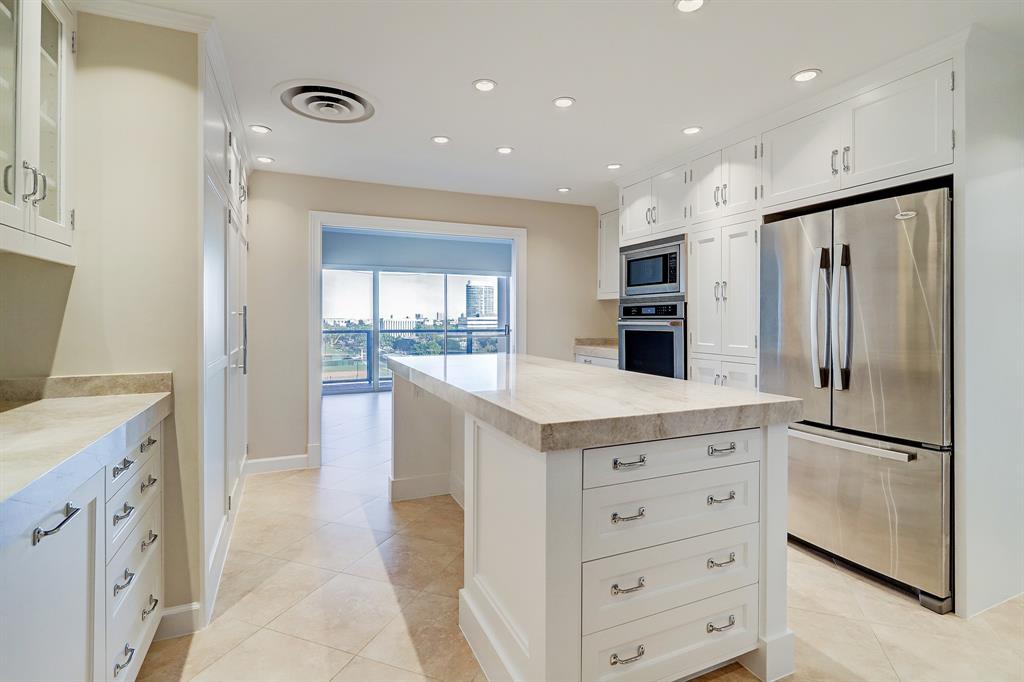 a kitchen with a refrigerator a sink and a oven