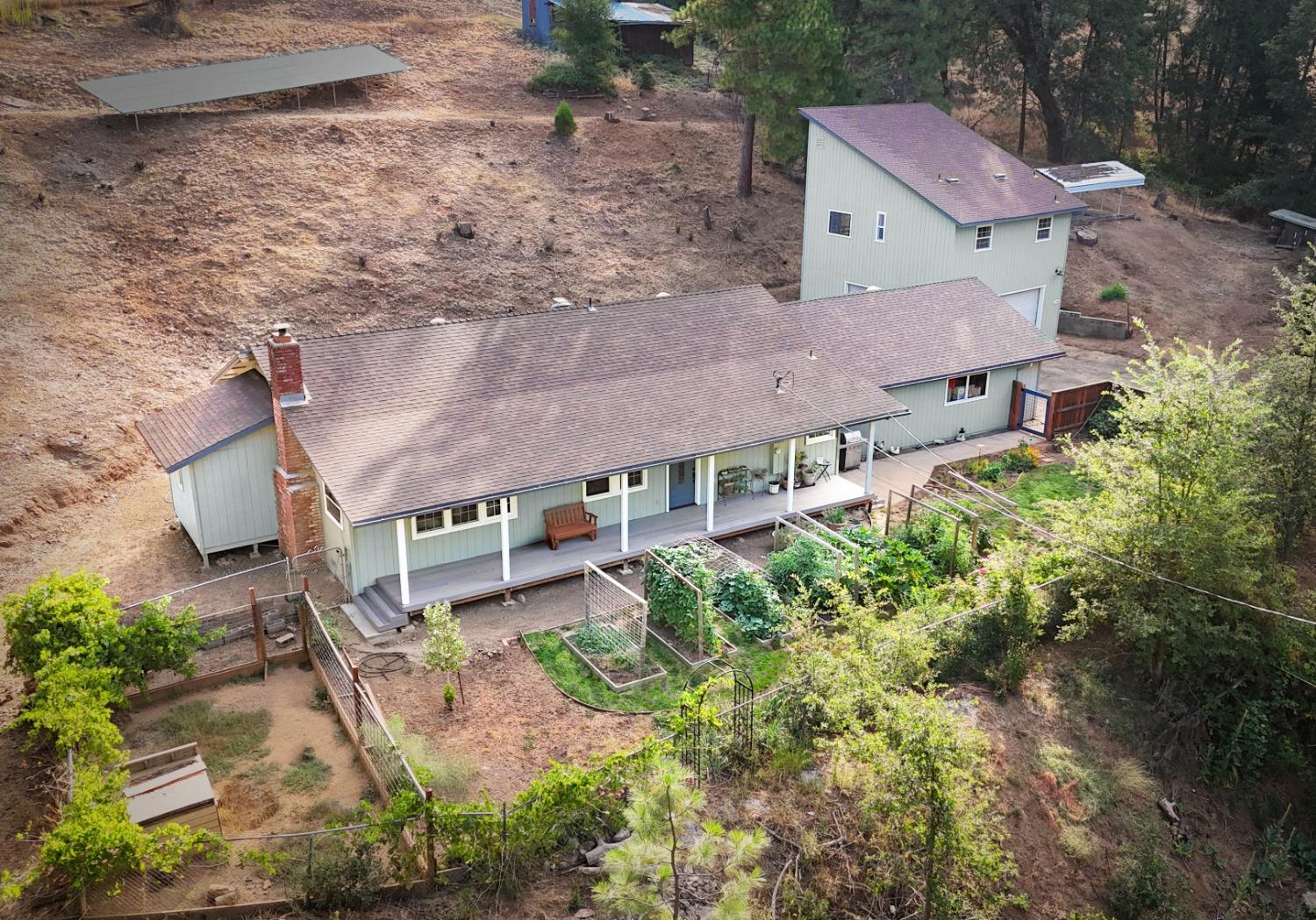 an aerial view of a house with a yard