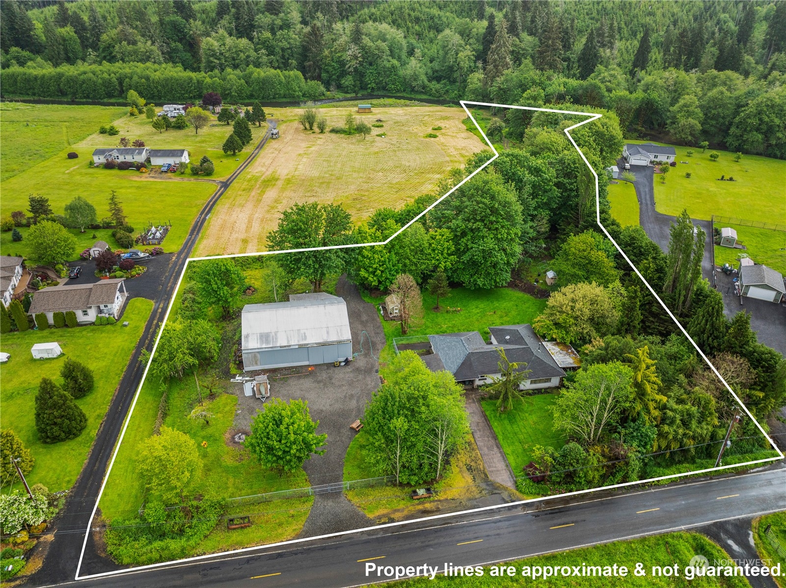 an aerial view of a residential houses with yard