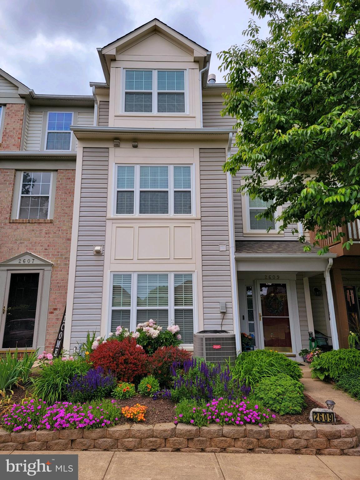 front view of a brick house with a yard