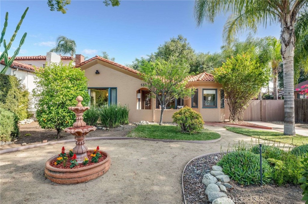 a front view of a house with a garden and patio