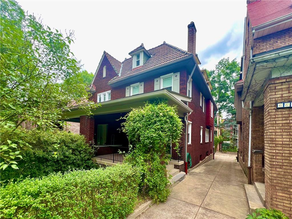 a front view of a house with plants