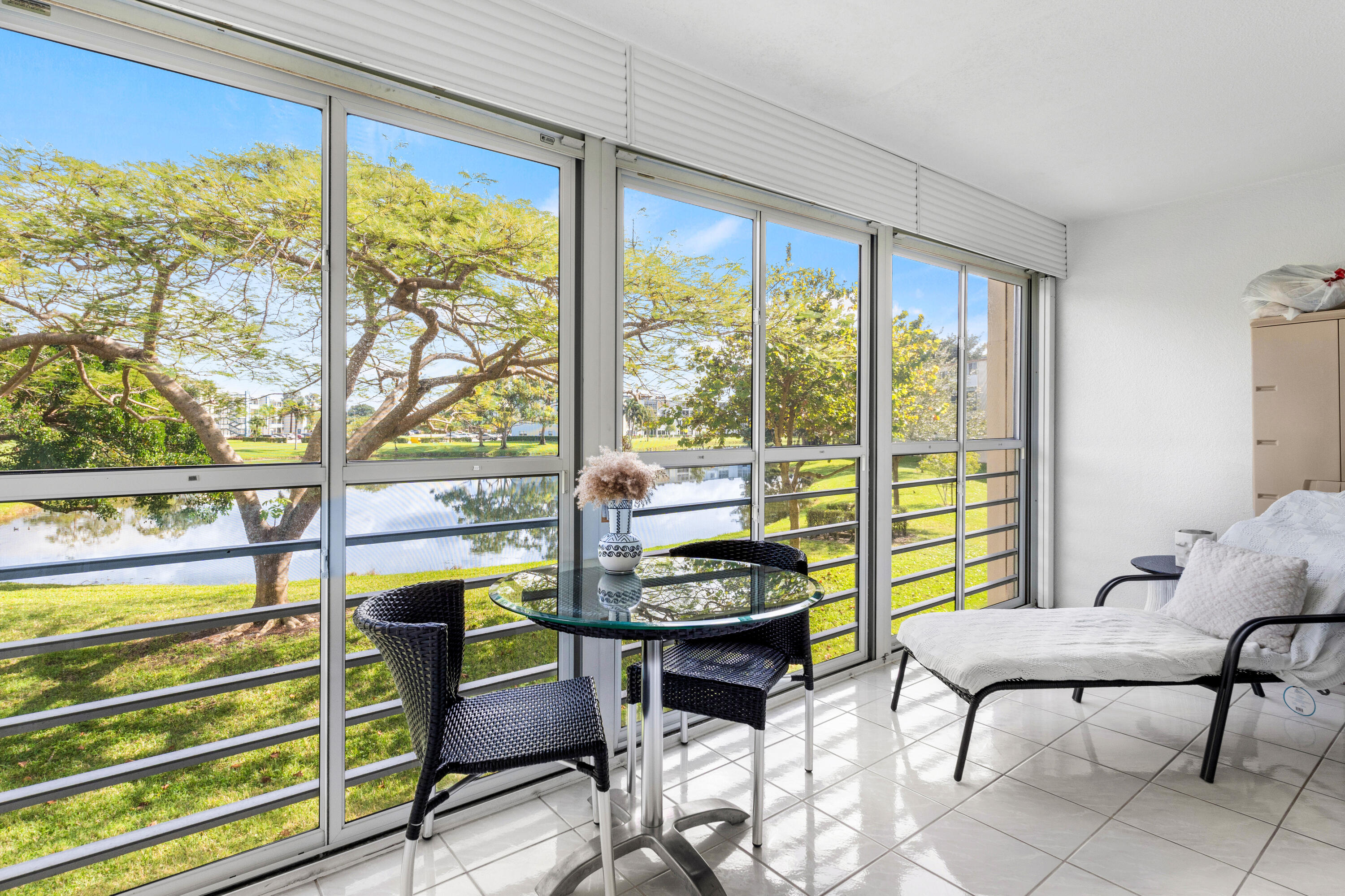 a living room with furniture and a floor to ceiling window