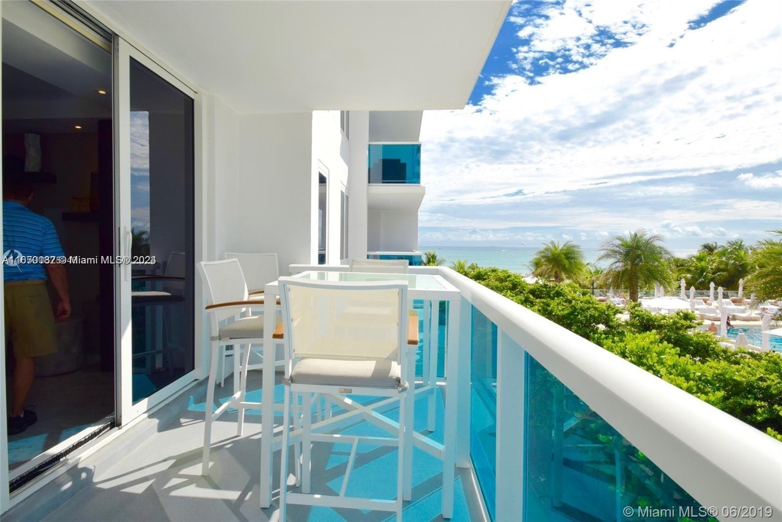 a balcony with table and chairs