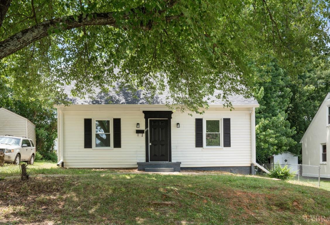 a house that has a tree in front of the house