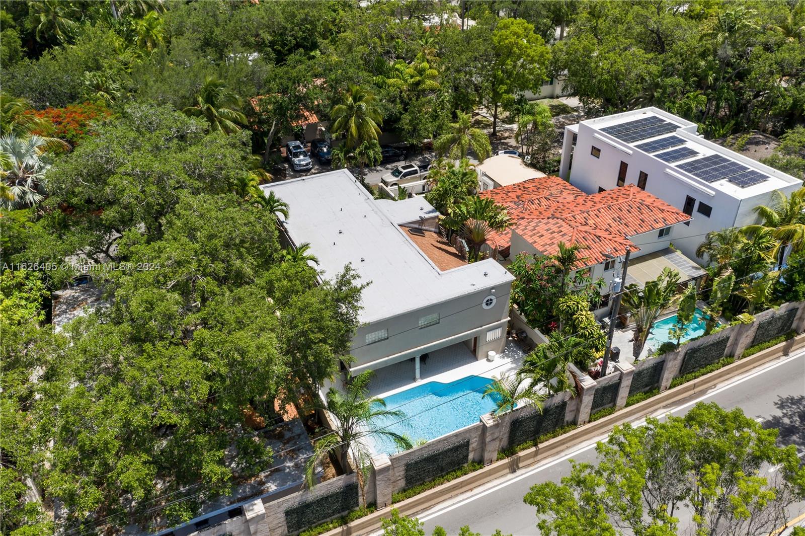 an aerial view of residential house with outdoor space and trees around