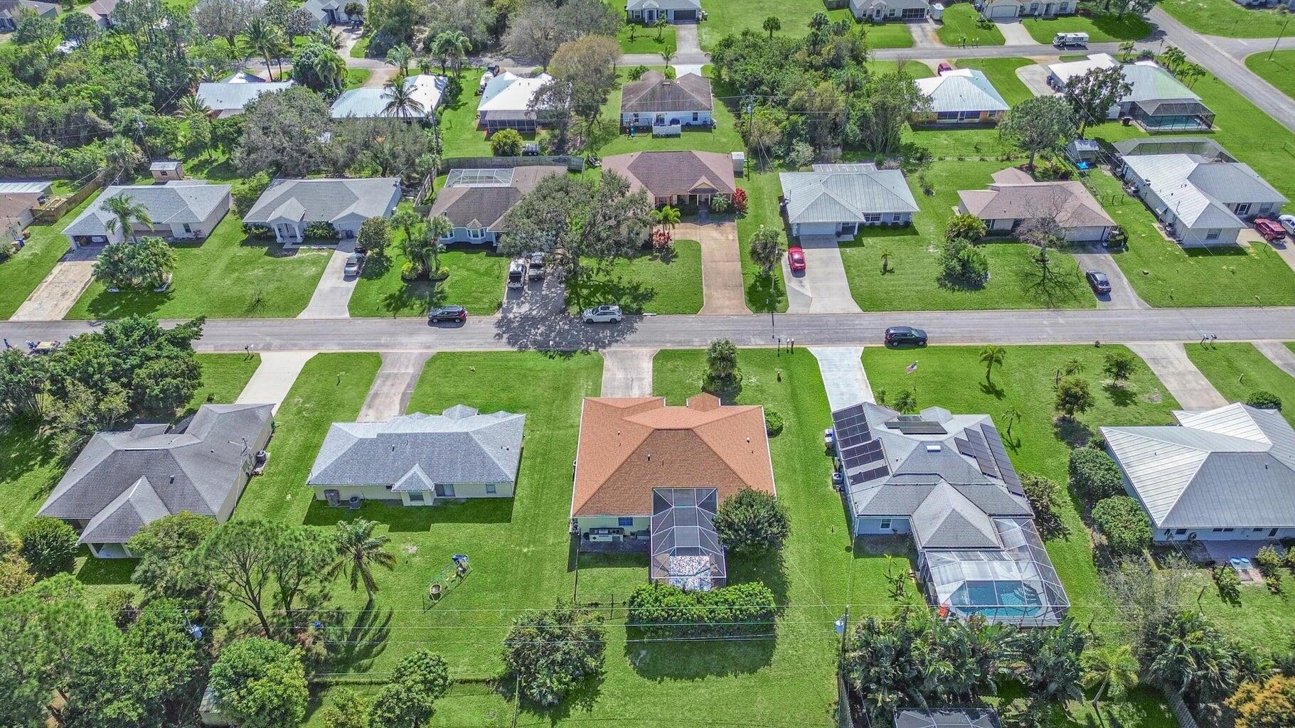 an aerial view of house with swimming pool outdoor seating and yard