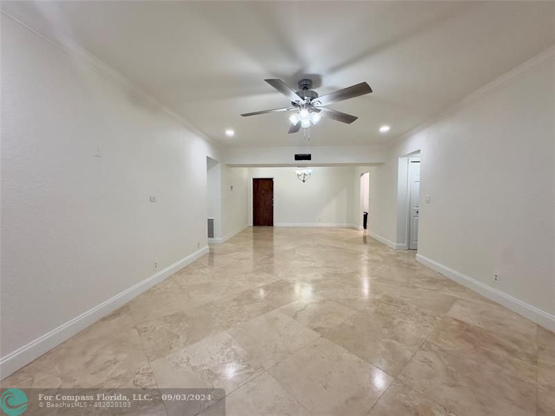 an empty room with fan and a ceiling fan