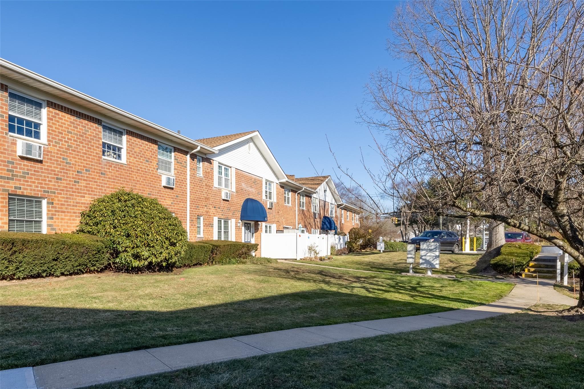 View of property exterior featuring a lawn