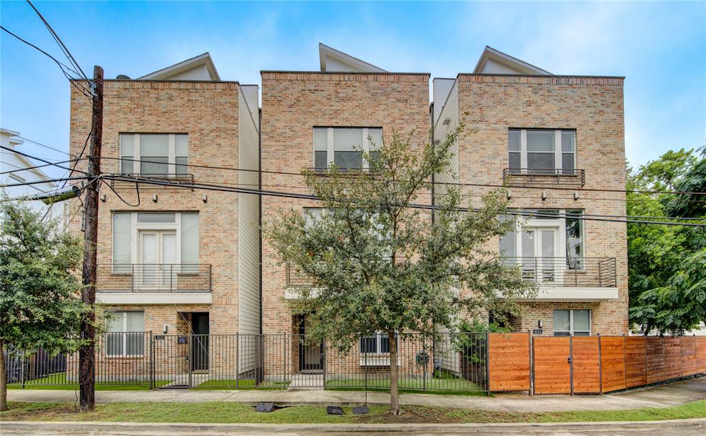 a front view of a residential apartment building with a yard