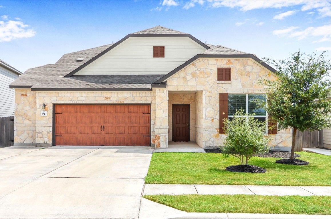 a front view of house with garage and yard