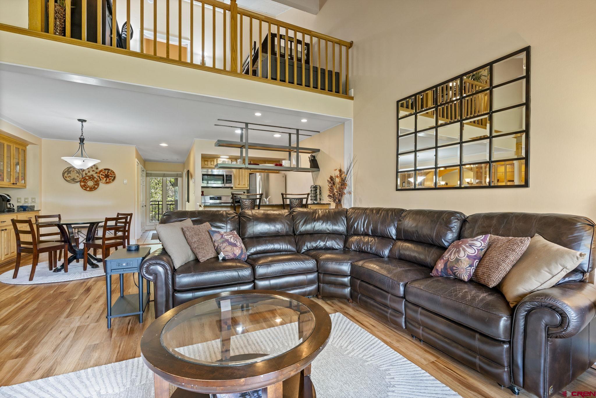 a living room with furniture a fireplace and a chandelier