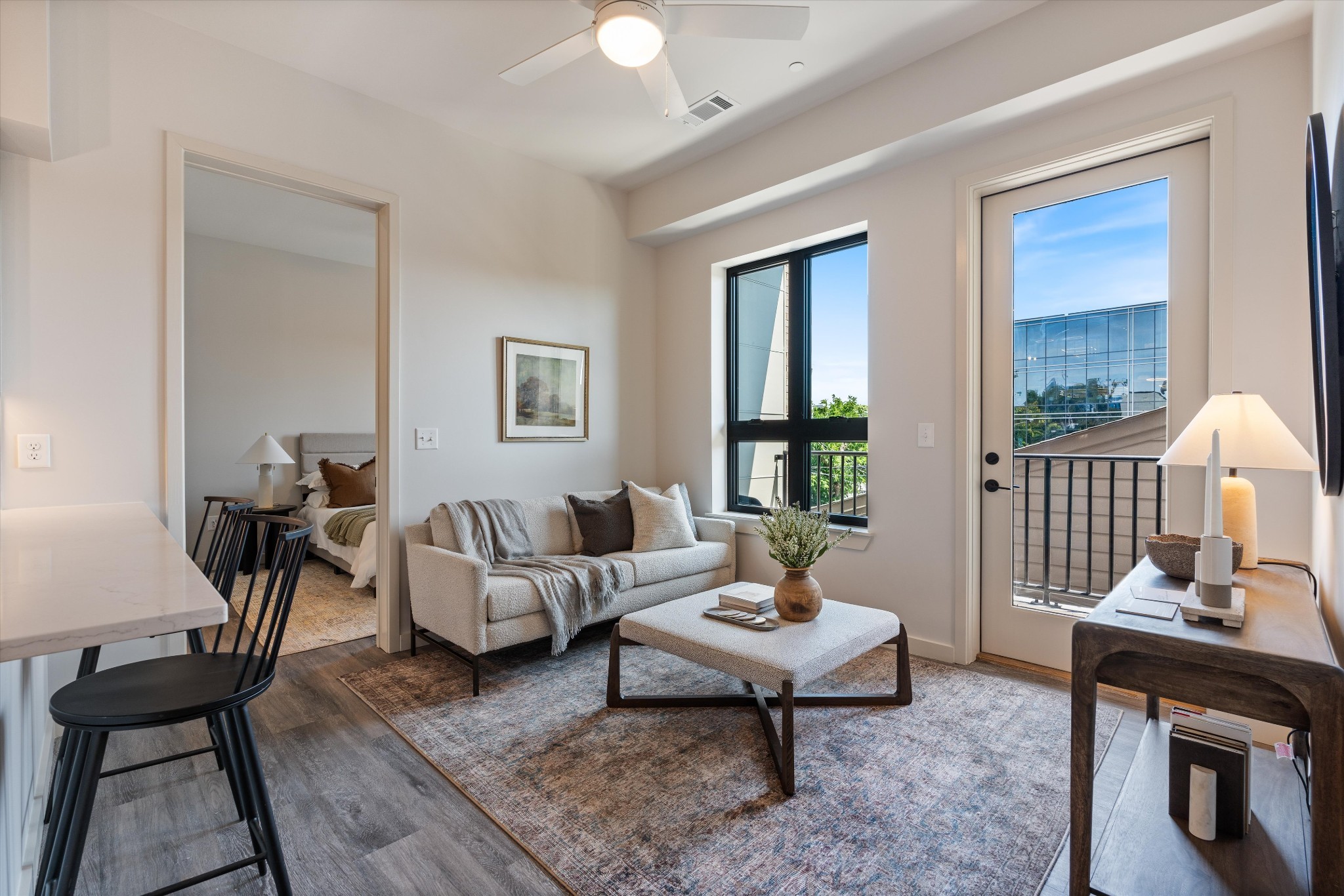 a living room with furniture a table and a window