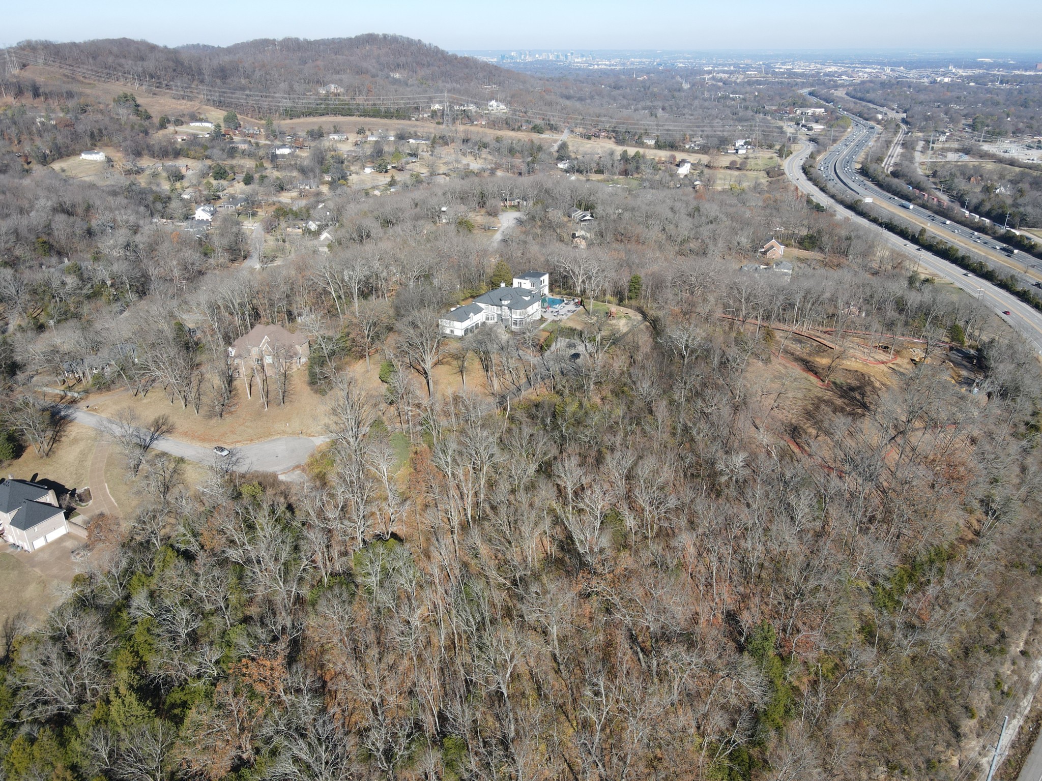 an aerial view of house with yard and mountain view in back