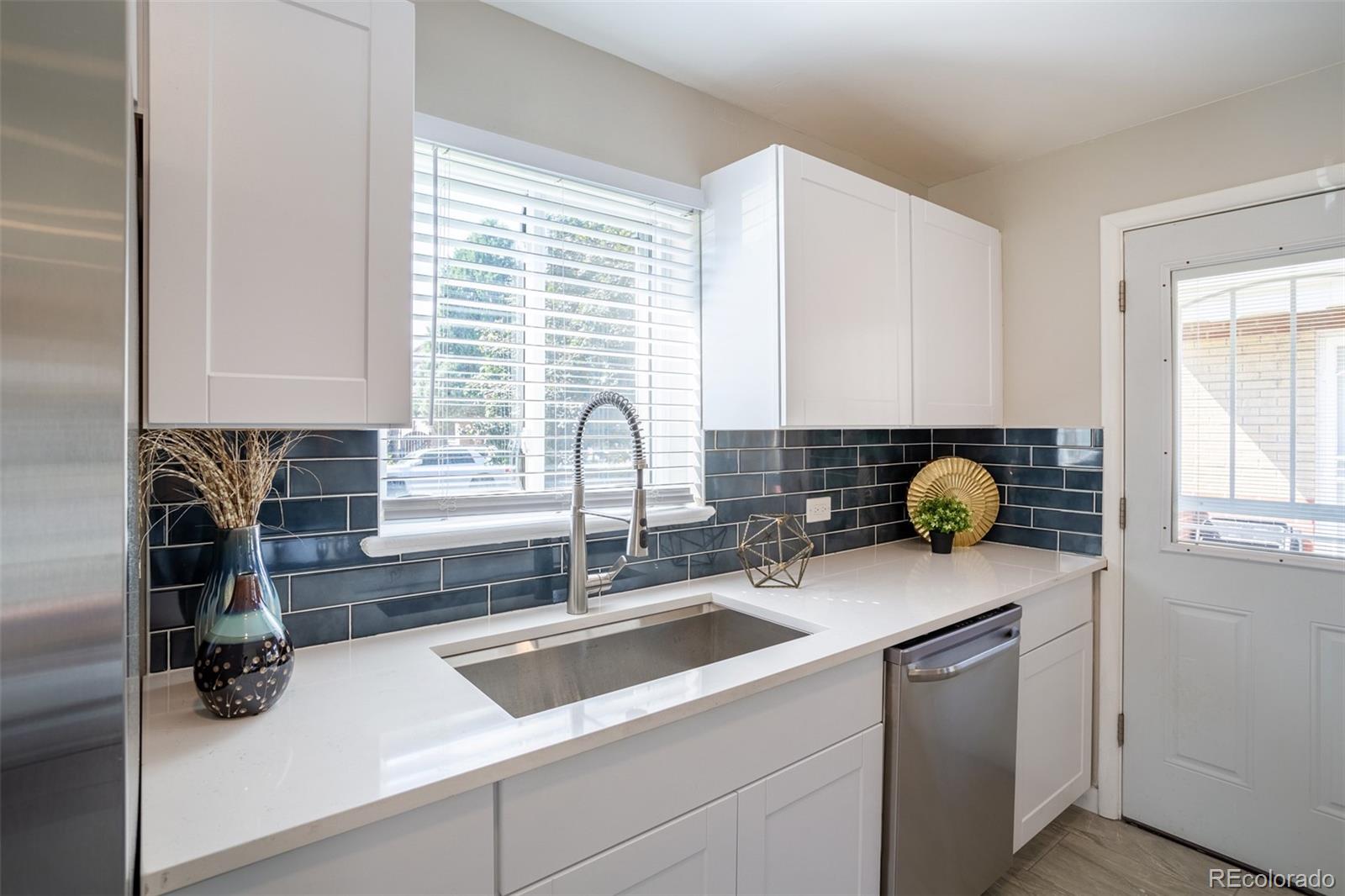 a kitchen with a sink cabinets and window