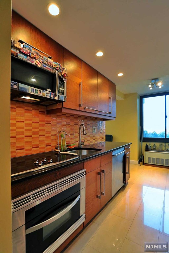 a kitchen with stainless steel appliances and cabinets