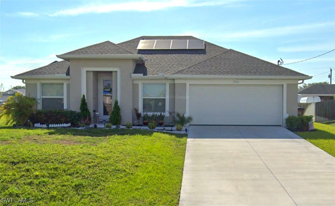 a front view of house with yard and outdoor seating