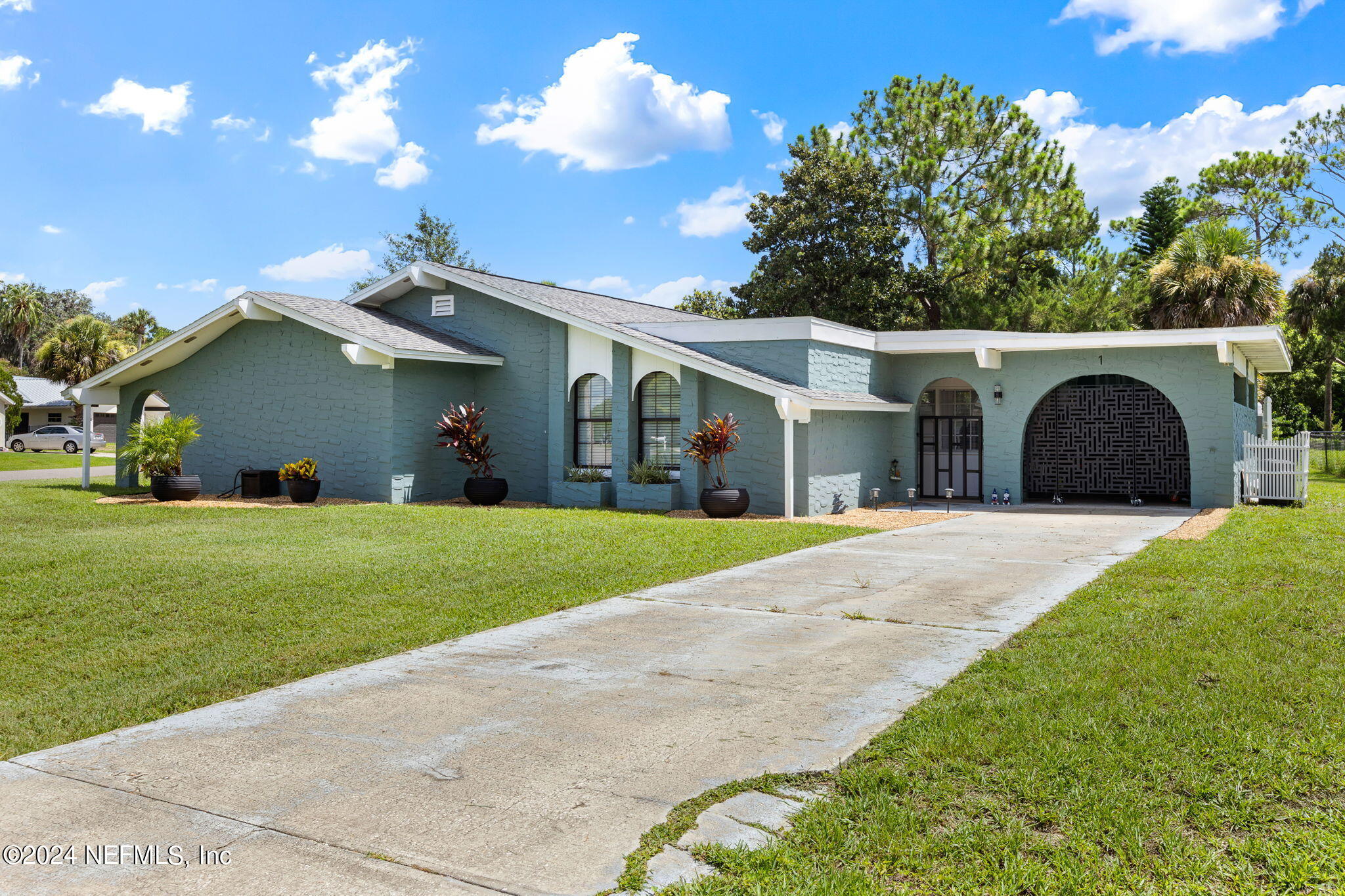 a front view of a house with a garden and yard