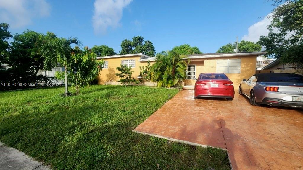 a view of a yard with a car parked in it