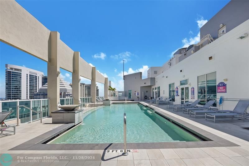 a swimming pool with outdoor seating and yard