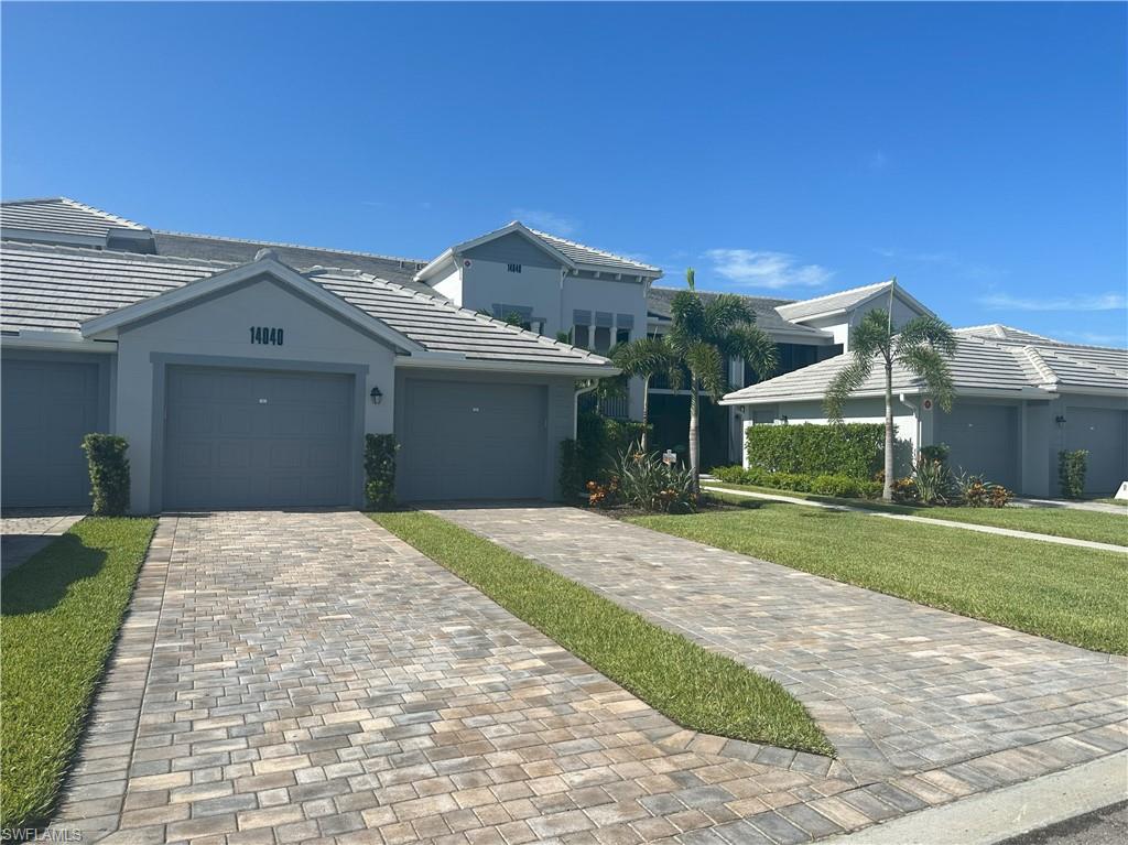 a front view of a house with a yard and garage