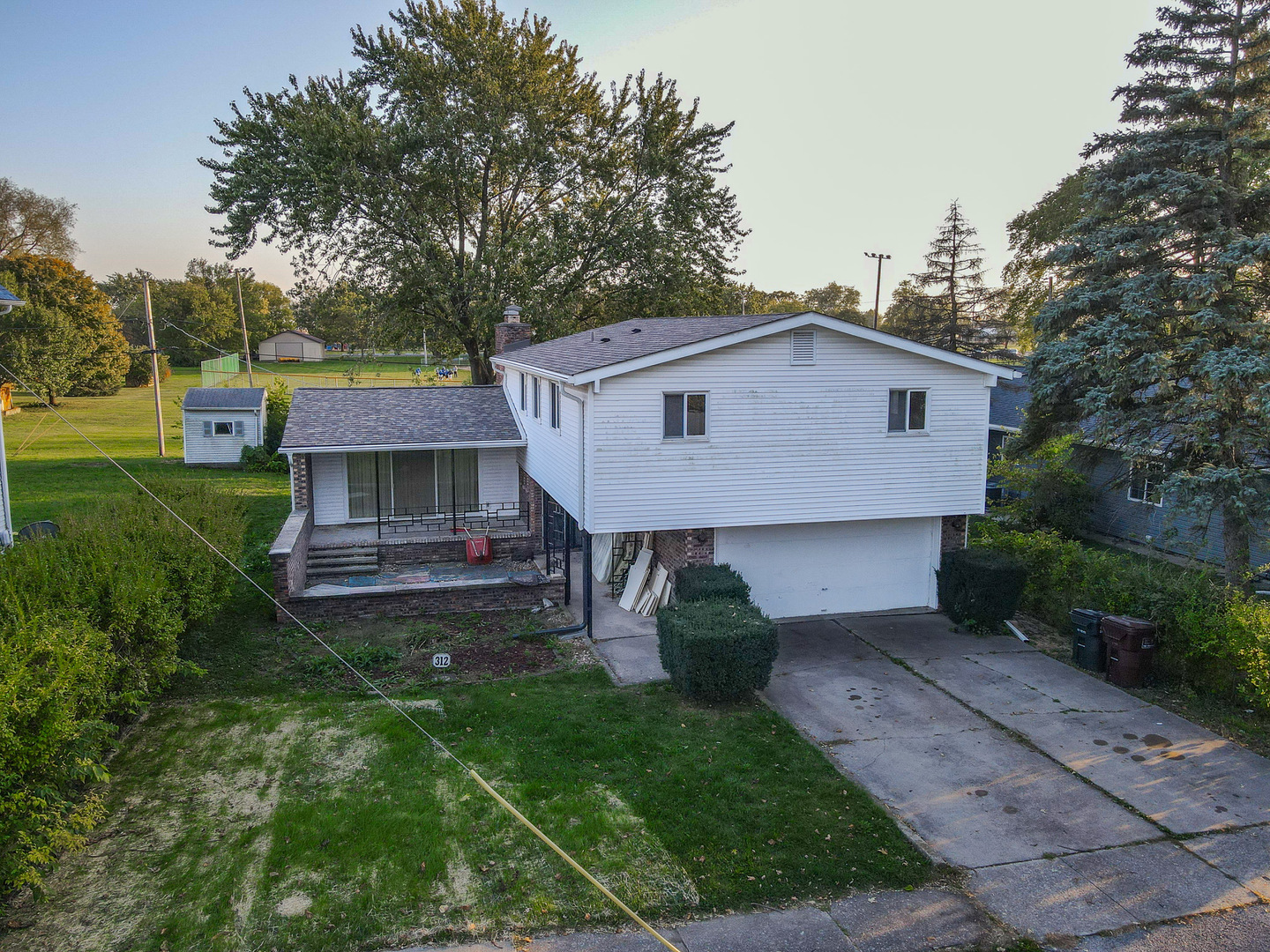 a view of a house with a yard patio and a garden