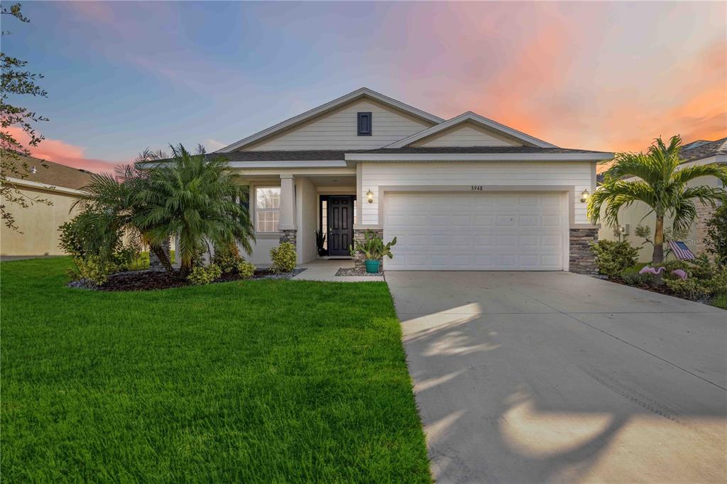 a front view of a house with a yard and garage