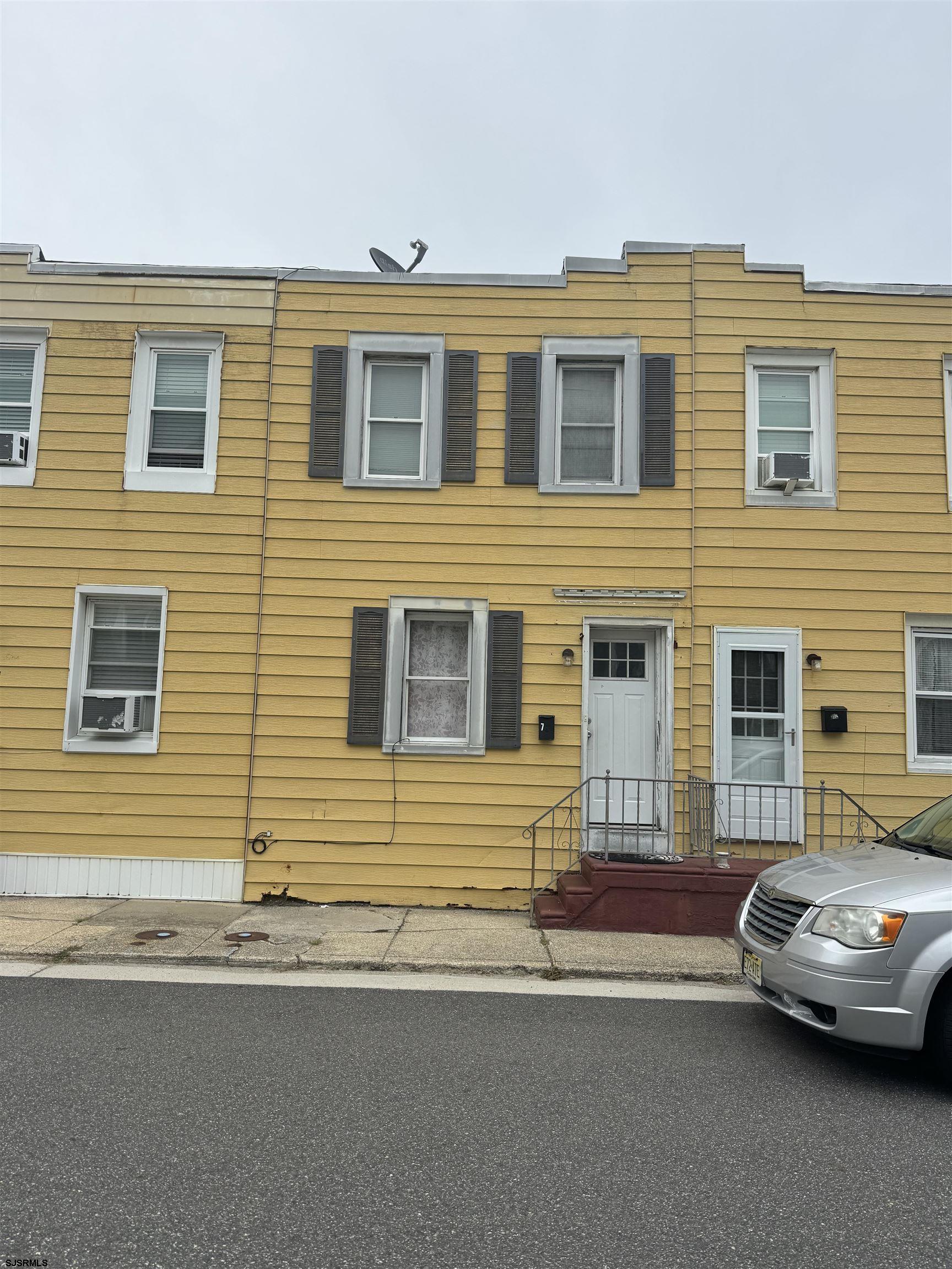 a view of a car parked in front of a house