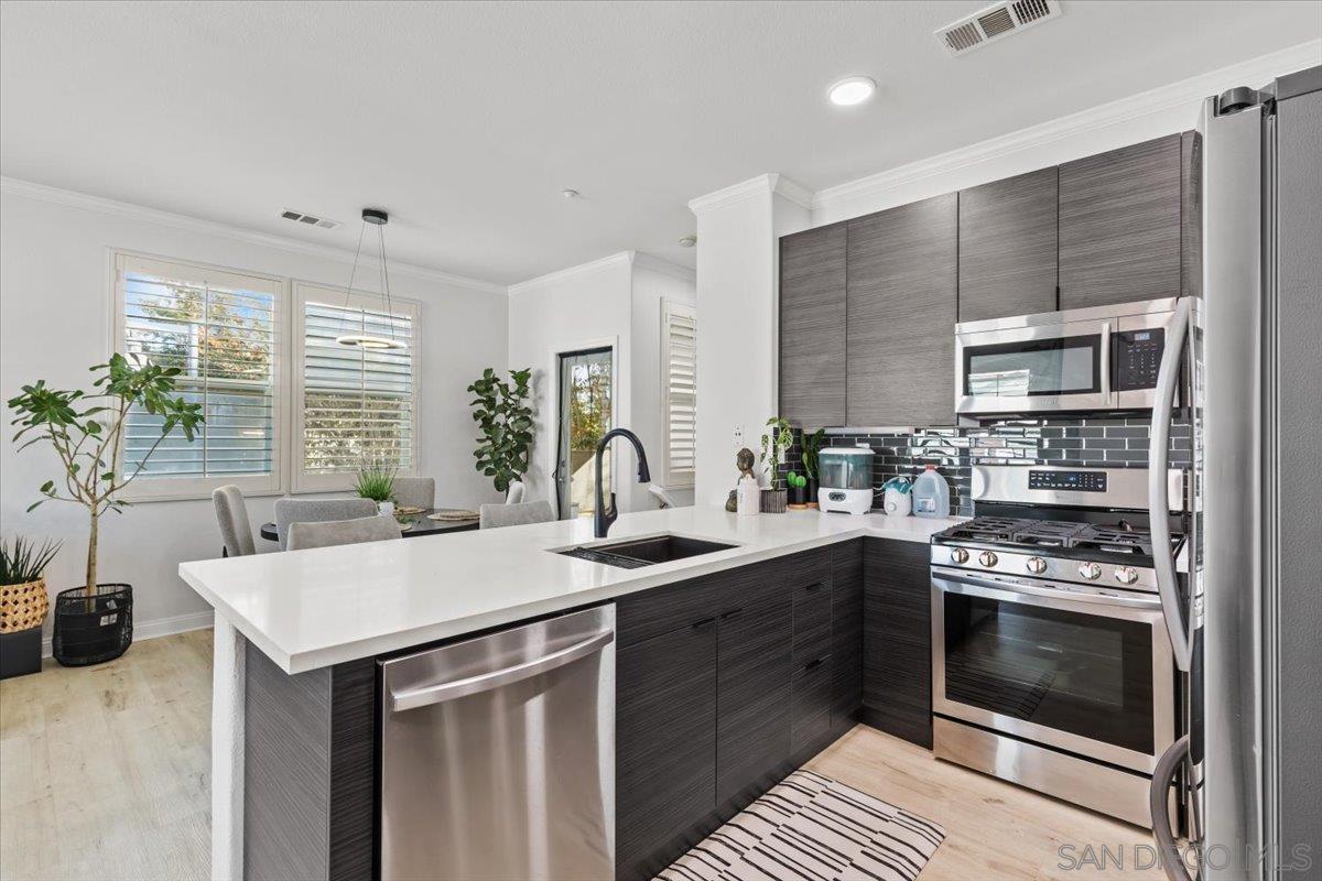 a kitchen with a sink stove and cabinets