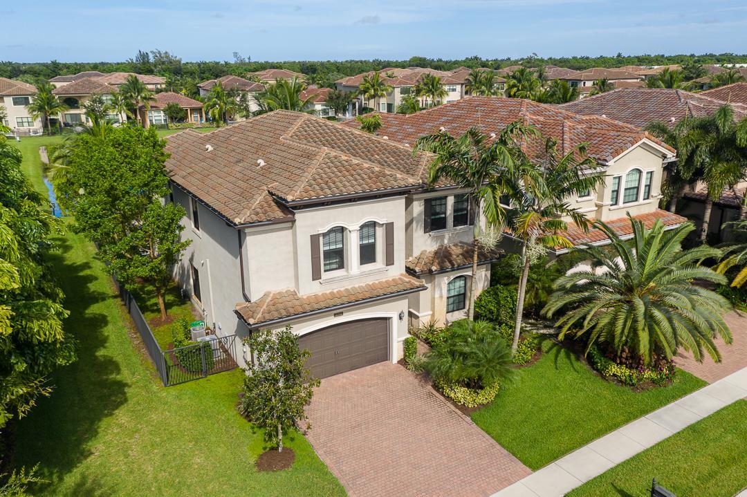 an aerial view of a house with a yard