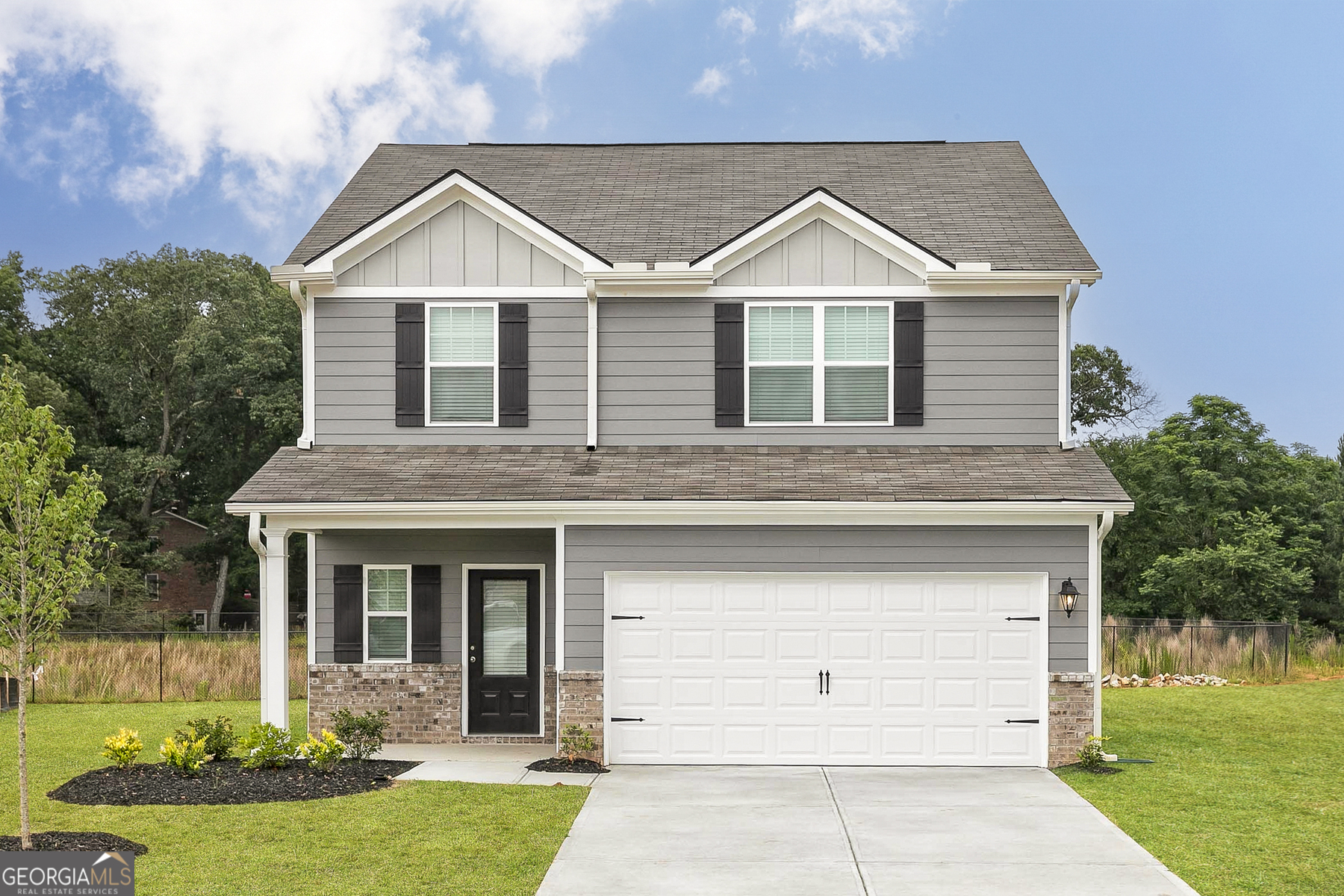 a view of a yard in front view of a house