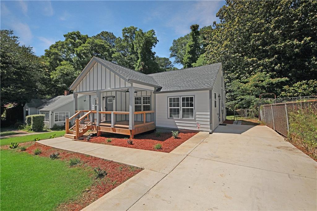 a view of a house with a yard patio and a garden