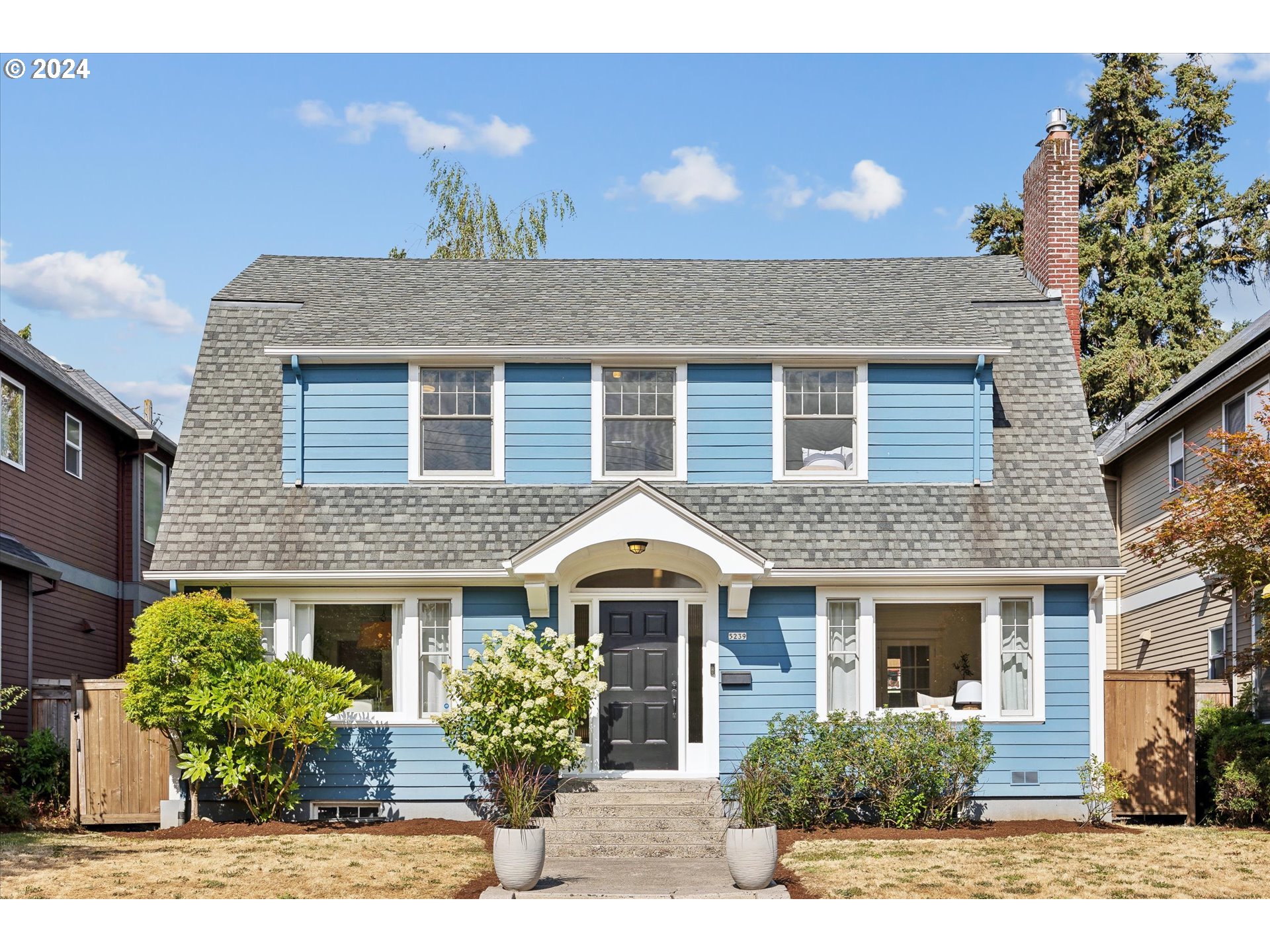 a front view of a house with a garden