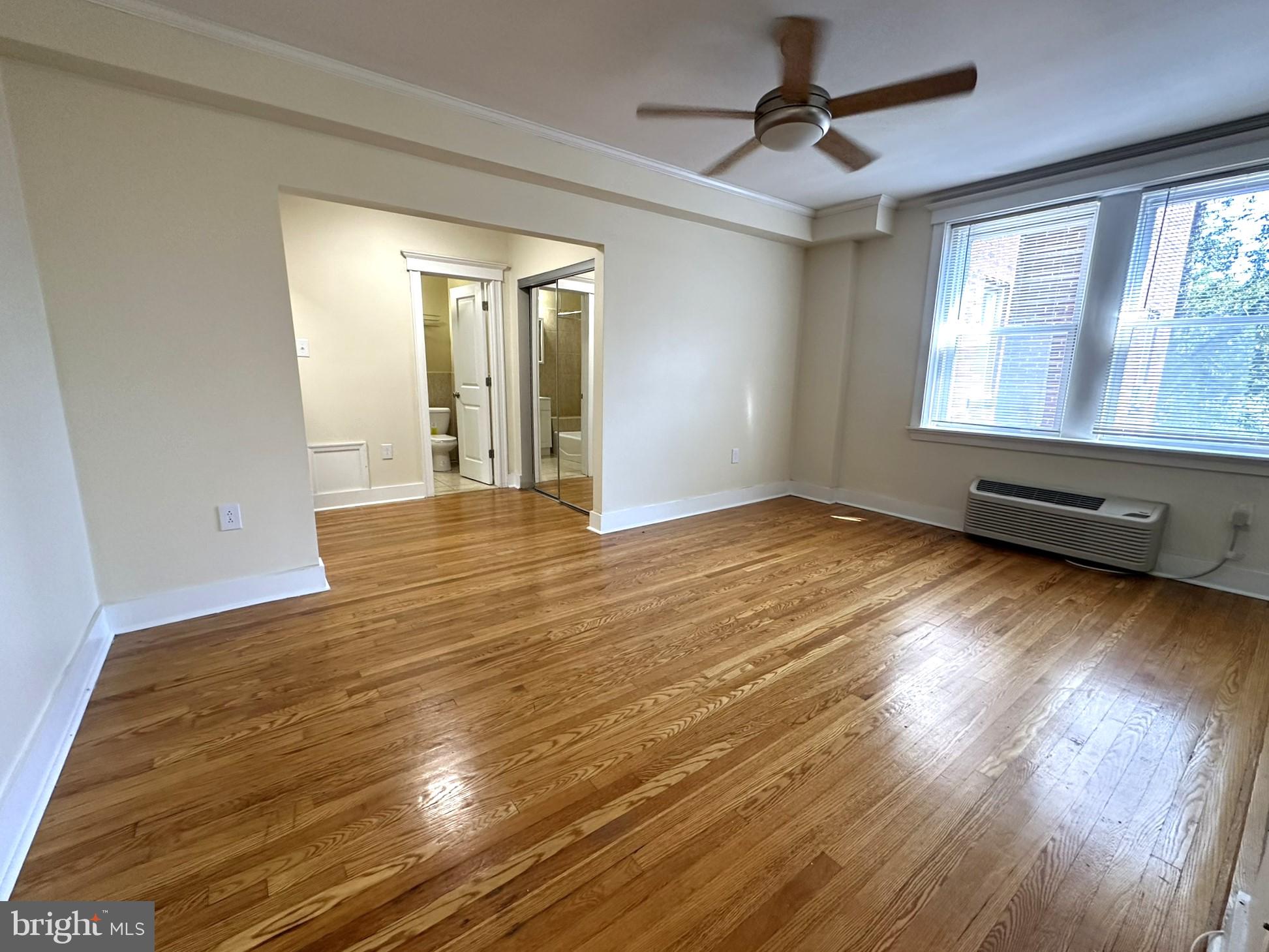 wooden floor in an empty room with a window