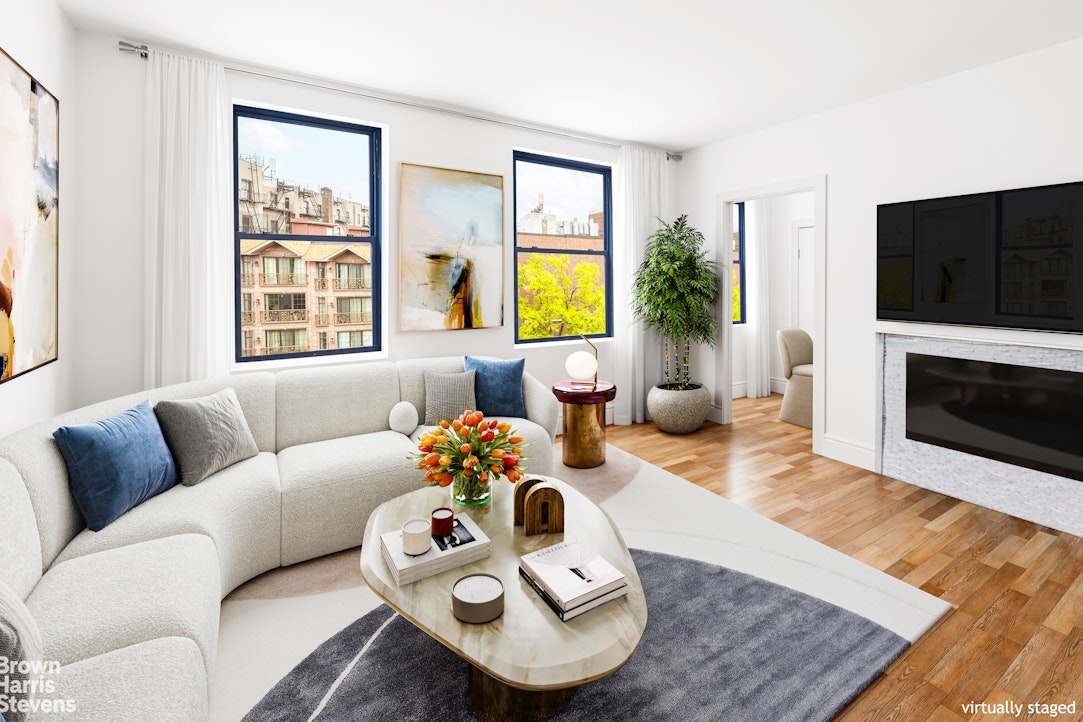 a living room with furniture flat screen tv and a fireplace