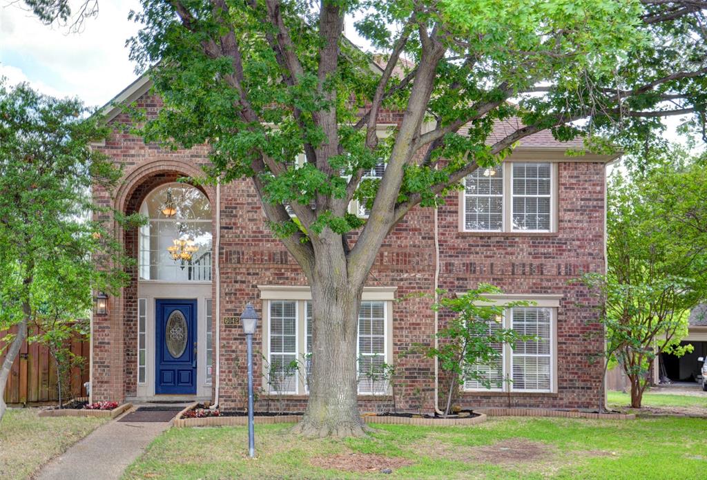 front view of a house with a garden