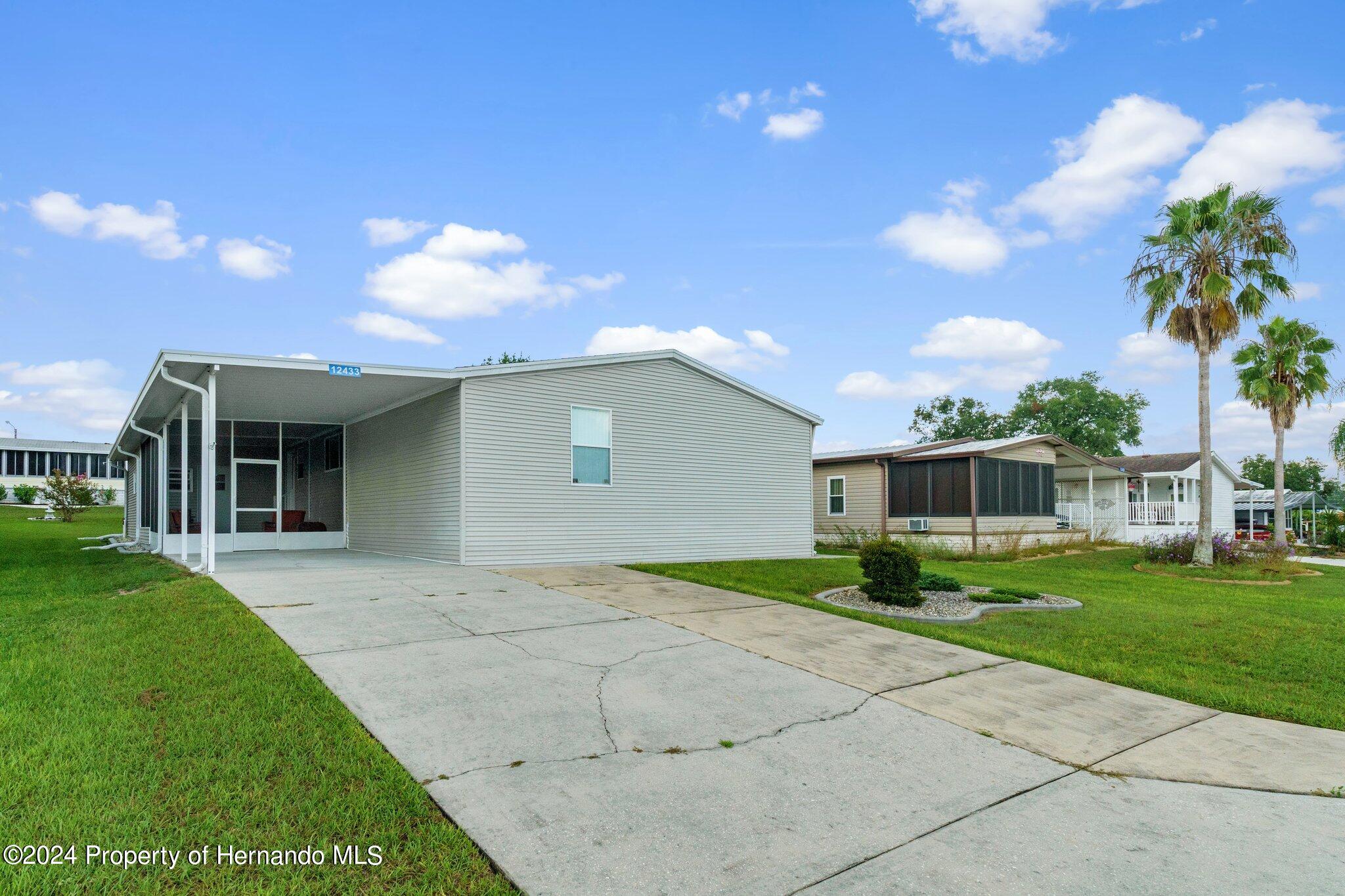 a view of a house with a yard and front view of a house