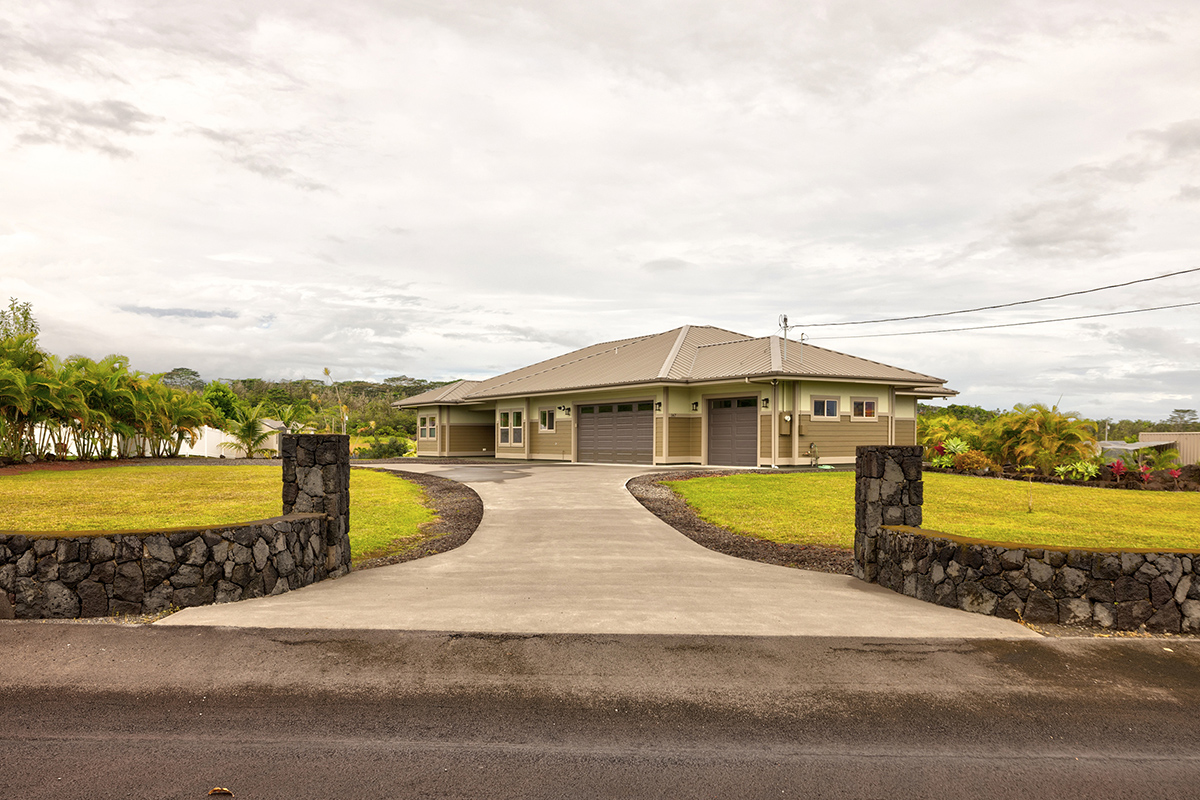 a view of a house with a yard and ocean view